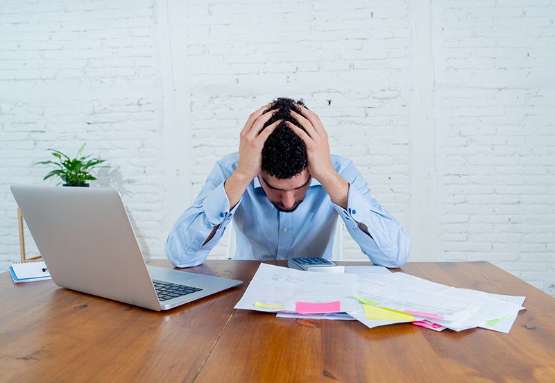 A small business owner stressed due to bookkeeping.