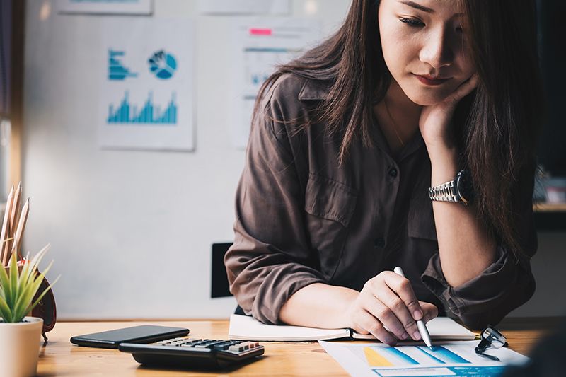 Businesswoman calculating finances with a calculator