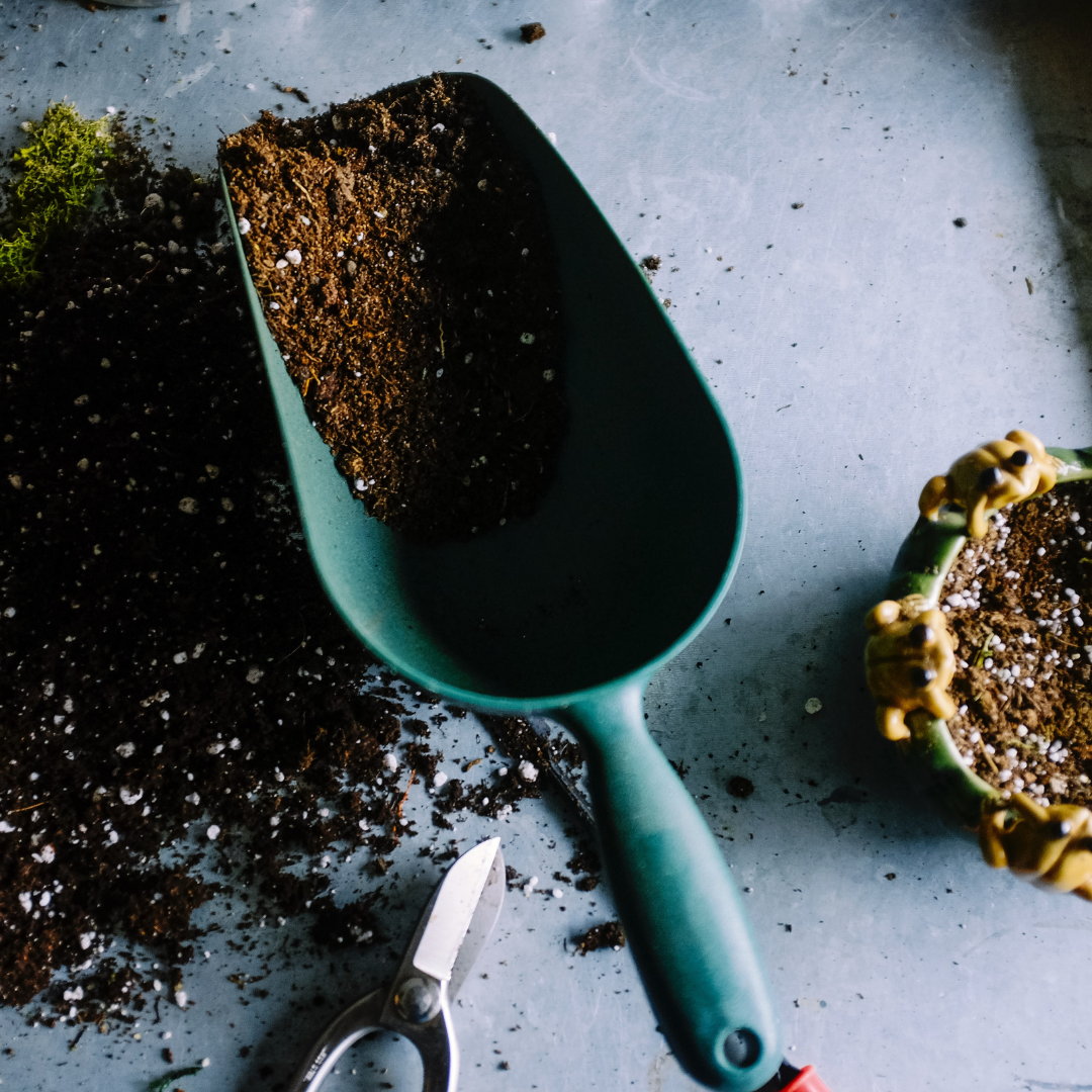 soil fertilizer in a green handle