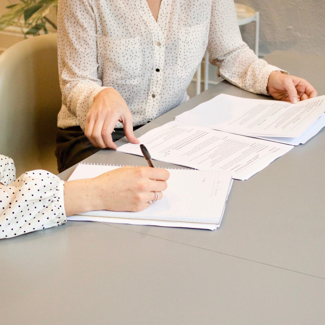 Individuals signing papers