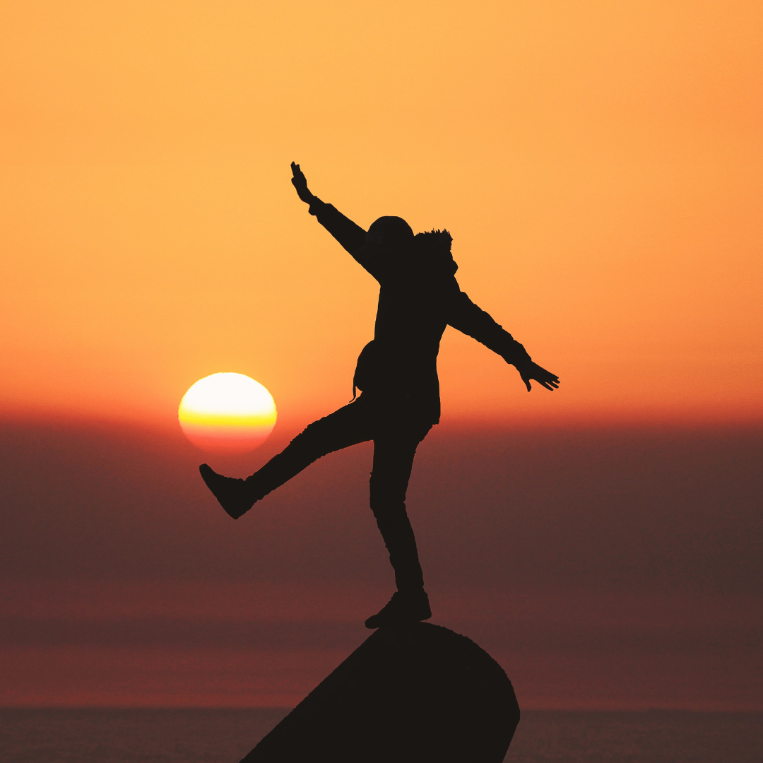 man's silhouette against sunset